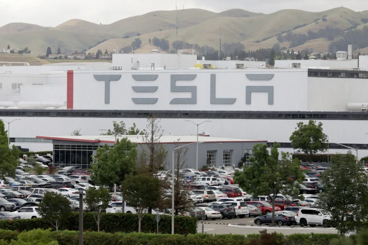 A Tesla Semi electric truck is parked at a distribution center.