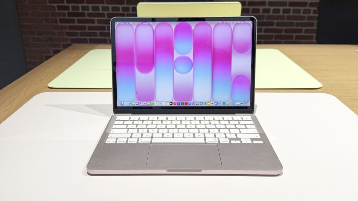 New Apple laptops are arranged on tables during a Kansas City Public Schools technology transition.