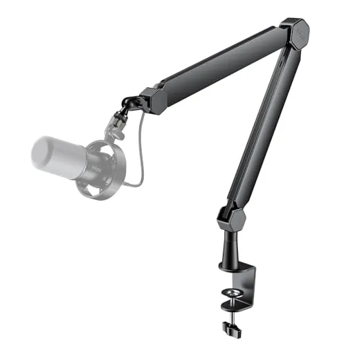 A desktop microphone arm kit is mounted on a desk, displaying adjustable joints and a professional studio microphone.
