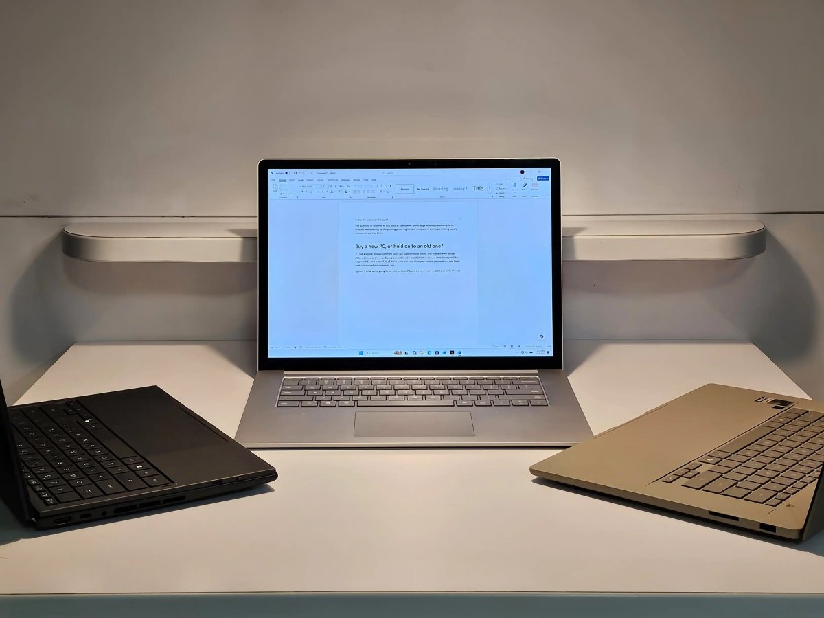 A side by side comparison displays a seven year old Surface Laptop 3 alongside modern Asus hardware.