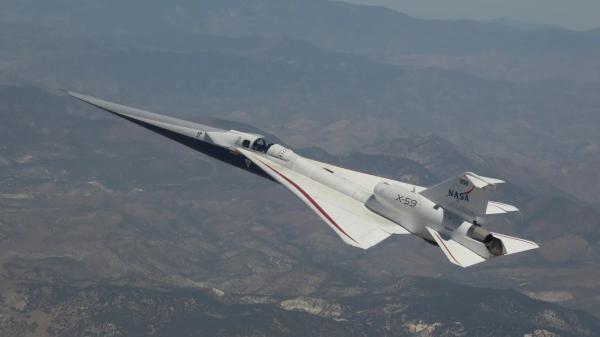The NASA X-59 quiet supersonic research aircraft sits on the tarmac.