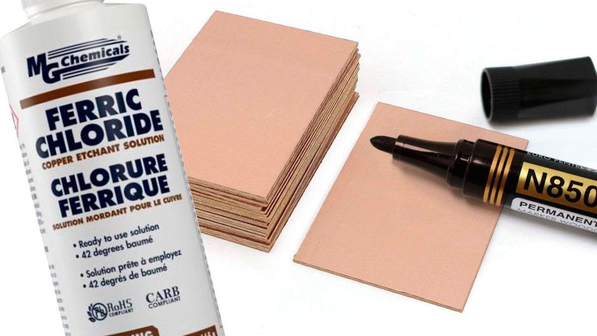 A hand-drawn printed circuit board layout is being etched with ferric chloride on copper clad material.
