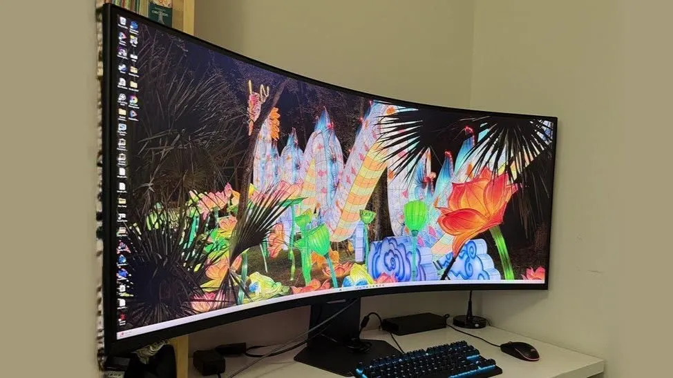 A fifty-two inch curved gaming monitor displays a dark screen.