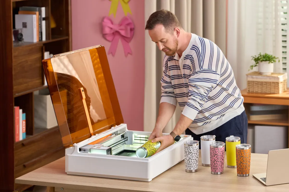 This modular desktop crafting machine has a swappable CMYK print head and laser engraving tool for paper, wood, and felt.