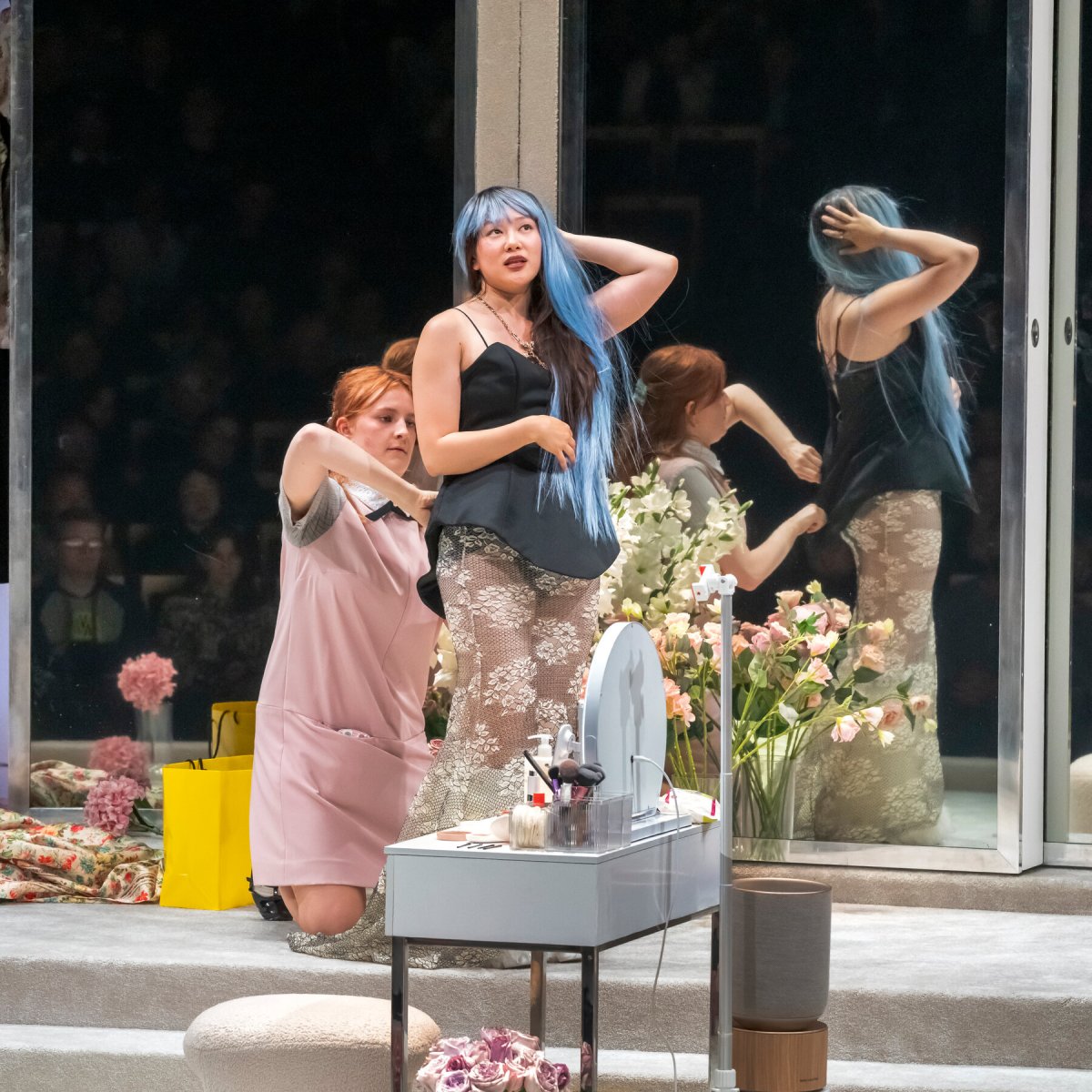 Actors perform on stage during a scene from the production of The Maids