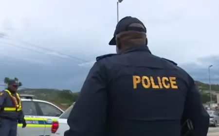South African police officers escort foreign nationals from a Durban church sanctuary amid rising tensions.