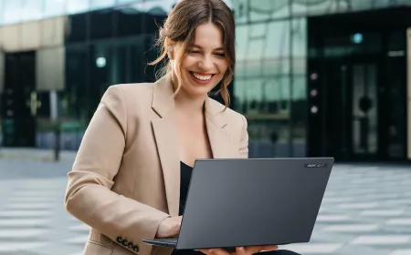 The Acer TravelMate P6 14 AI laptop is shown open on a desk.