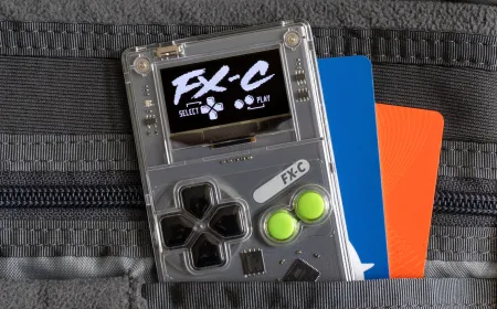 The Arduboy FX-C handheld console is shown from the front, highlighting its credit card size and monochromatic screen.