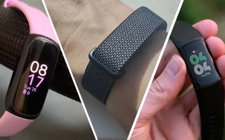 Fitbit fitness trackers and smartwatches are arranged on a display table.
