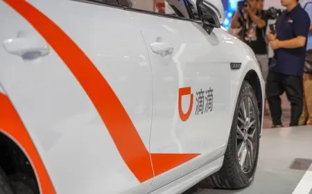 A Didi driverless robotaxi navigates designated urban streets in Guangzhou during its continuous trial.