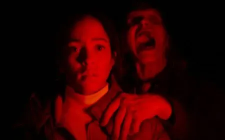 The film still captures tense road trip dread through dramatic lighting and confined interior framing.
