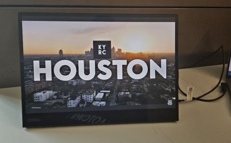 The Lenovo ThinkVision M14t Gen 2 portable monitor is shown with its built-in stand extended and USB ports visible.