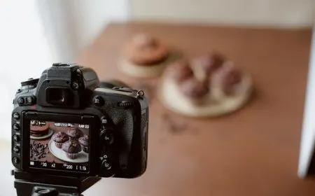 photographer adjusting camera settings while composing a scene with natural light