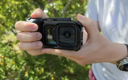 A GoPro Mission 1 Pro camera rests on a surface with its new grip attached.