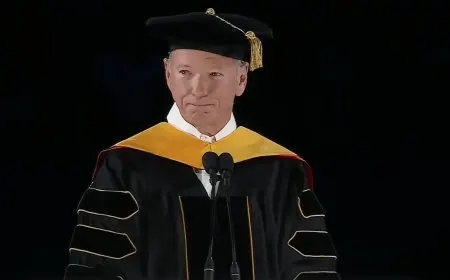 Graduates confront tech executives about artificial intelligence during a university commencement ceremony.