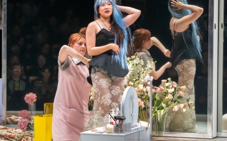 Actors perform on stage during a scene from the production of The Maids