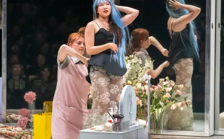 Actors perform on stage during a scene from the production of The Maids