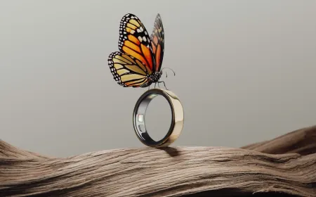 The Oura Ring 5 smart ring rests on a display stand to show its compact design and sensor layout.