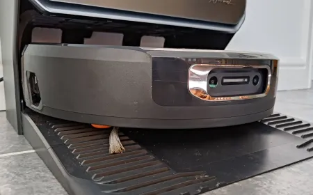 The Narwal Flow 2 robot vacuum and mop sits on a smooth floor during spill testing.