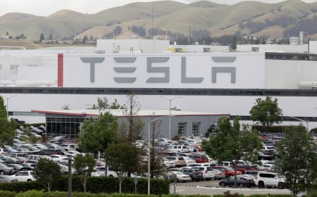 Tesla hits record high as shares surpass $1,000 for first time