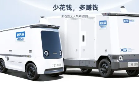 A Neolix autonomous delivery robot navigates an urban street.