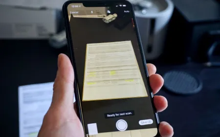 iPhone screen showing the native document scanner capturing a physical paper to create a PDF file.