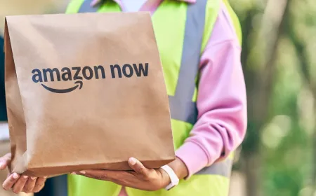 Amazon delivery vehicles depart a micro fulfillment center for thirty minute grocery service across US cities.