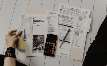 A tax professional reviews financial documents during a client consultation.