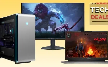 A retail display features Dell and Alienware laptops and monitors alongside promotional discount tags.