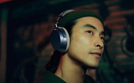 The Sennheiser Momentum 5 Wireless headphones are displayed on a neutral surface.