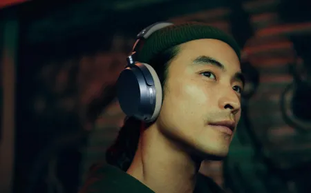 The Sennheiser Momentum 5 Wireless headphones are displayed on a neutral surface.