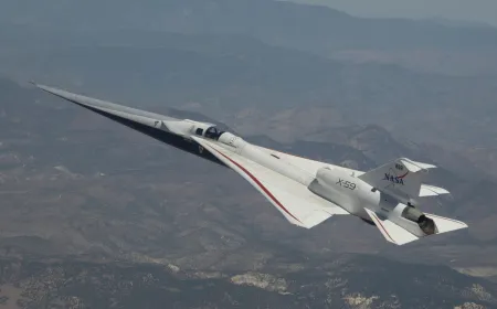 The NASA X-59 quiet supersonic research aircraft sits on the tarmac.