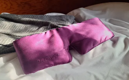 Two contoured sleep masks rest side by side on a light surface.