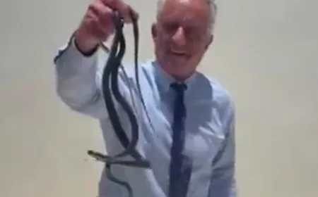 The United States Health Secretary handles two wild snakes without protective gear in viral footage.