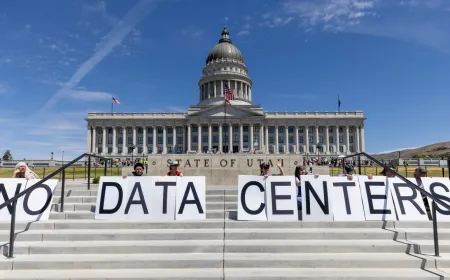 Demonstrators protesting near a large artificial intelligence data center