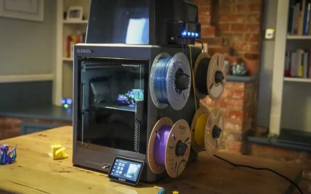 Three 3D printers from Elegoo, Bambu Lab, and Creality are displayed side by side for Memorial Day discount comparison.