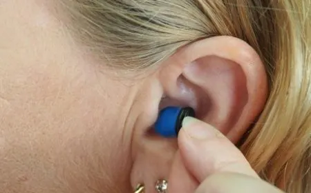 Standard earbuds capture heartbeat vibrations through accelerometers to verify user identity passively.