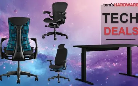 A Herman Miller ergonomic chair sits next to an adjustable desk in a bright workspace.