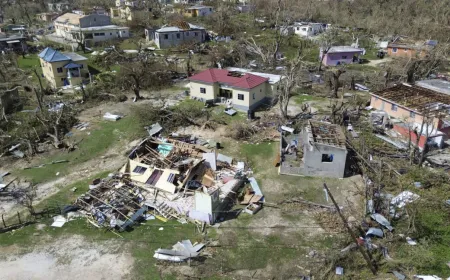 A weather map displays projected Atlantic hurricane tracks and coastal emergency preparedness zones for 2026.