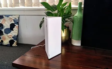Two MSI Roamii BE Pro Wi-Fi 7 mesh router nodes arranged on a desk for performance testing.