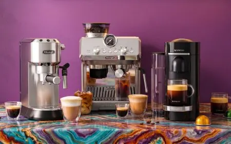 Three De'Longhi coffee makers stand side by side, representing the Dedica, La Specialista Arte Evo, and Vertuo Plus Deluxe.