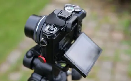 The Panasonic Lumix L10 compact camera sits beside the Olympus OM-D E-M10 Mark IV mirrorless camera.