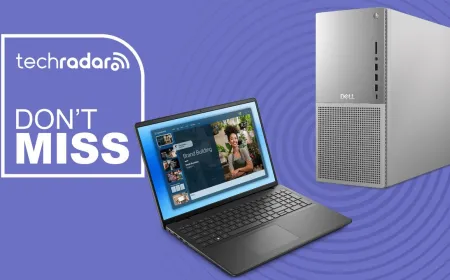 Dell business laptops and desktop towers are arranged on a promotional display table.