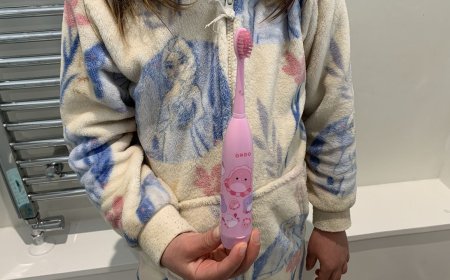 Ordo Sonic Kids battery toothbrush with a standard brush head attached, displayed on a neutral surface.