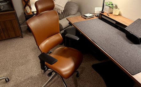 Ergonomic office chairs with temperature regulation and massage systems displayed for a Memorial Day sale.