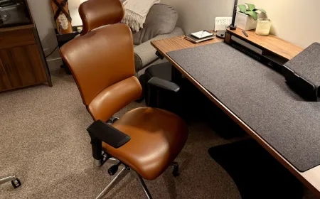 Ergonomic office chairs with temperature regulation and massage systems displayed for a Memorial Day sale.