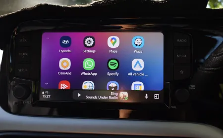 The Android Auto beta dashboard displays swipeable media cards for switching between active audio applications.