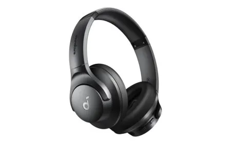 Anker Soundcore Q20i over-ear headphones displayed alongside a compact carrying case and USB cable