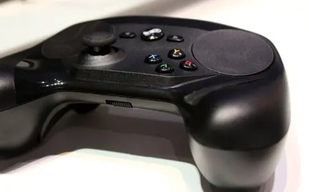 Exposed metal contact points are visible on the Steam Controller charging puck.