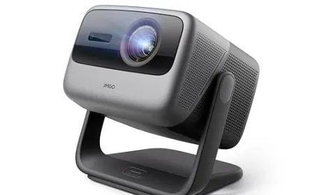 A laser projector displays a bright image on a wall in a residential living space.